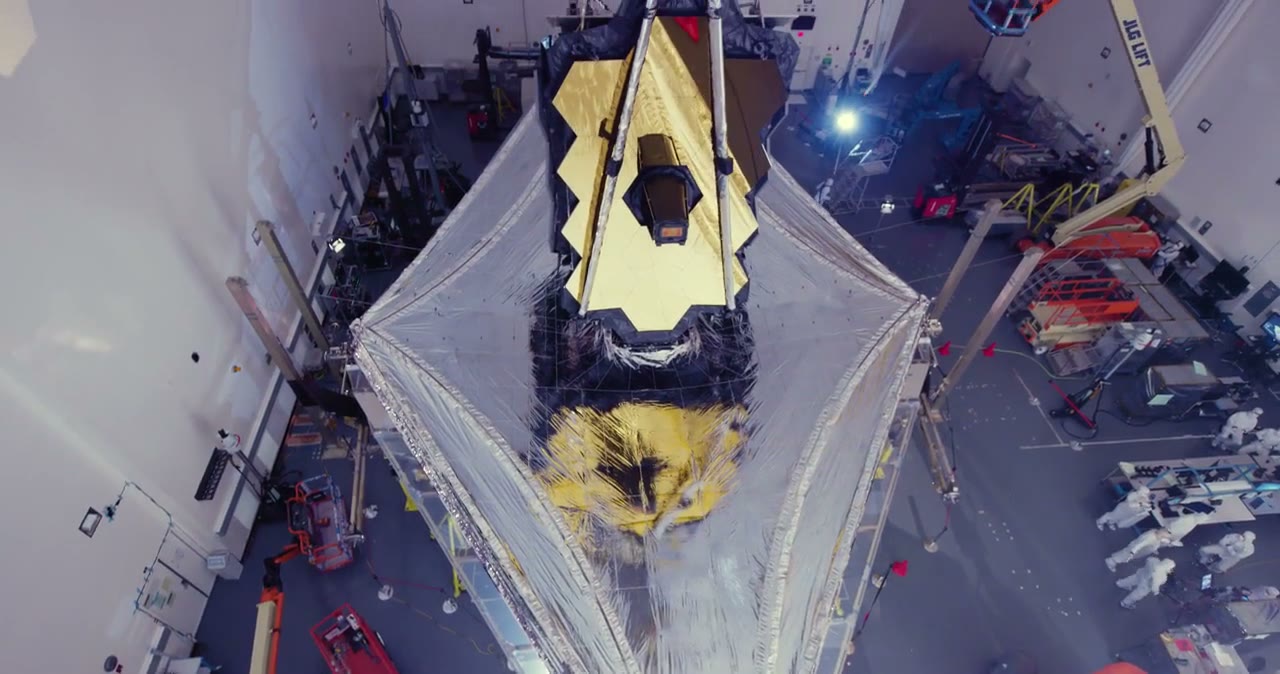 The Webb telescope's gold sunshield, fully deployed in a cleanroom.