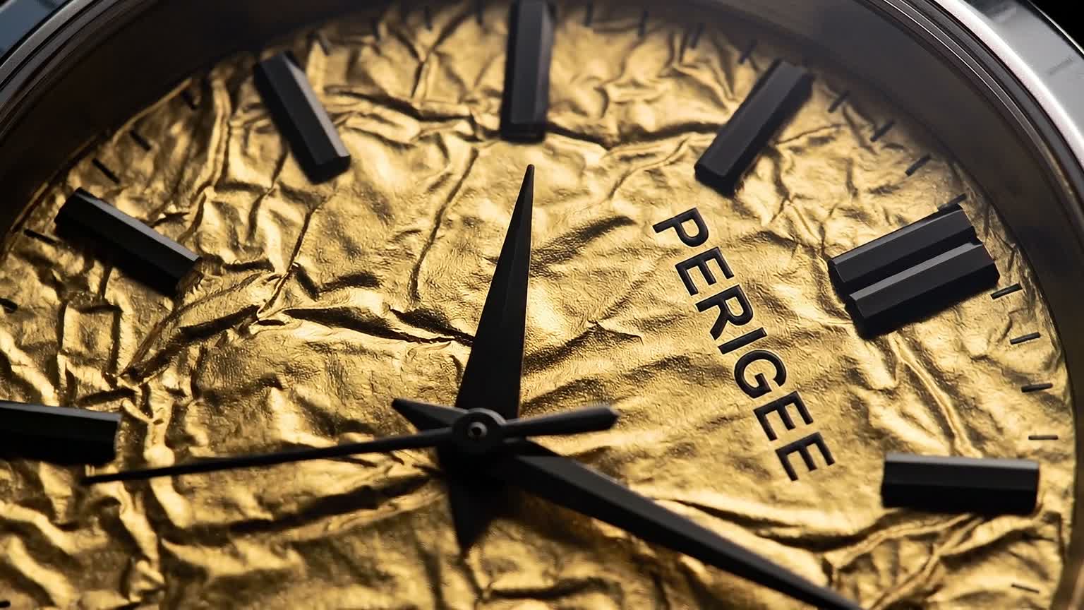 Film frame: the crinkled gold foil dial in close-up.